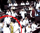 A scene of the scuffle (shown in the circle here) that broke out between a SP and a BSP Members of the Parliament in the Rajya Sabha during the Parliament's monsoon session in New Delhi on Wednesday. PTI Photo /TV GRAB