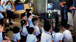 Reigning them in Young students being taught the basics of rainwater harvesting. A model of the technique (sbelow).