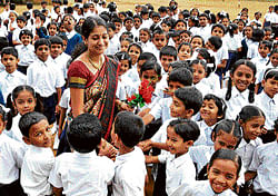 Students greet their teacher with flowers on the occasion of Teachers Day at SSM Public School, Nelagedaranahalli in Bangalore on Wednesday. DH Photo