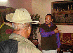 Suspect Zafar Sollapures father Sheikh interacts with police at his house in Hubli on Wednesday. DH Photo