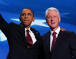 Former U.S. President Bill Clinton stands with Democratic presidential candidate, U.S. President Barack Obama (R) on stage during day two of the Democratic National Convention at Time Warner Cable Arena AFP