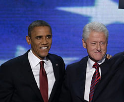 Former President Bill Clinton waves to the delegates as he stands with President Barack Obama after Clinton addressed the Democratic National Convention in Charlotte, N.C., on Wednesday, Sept. 5, 2012. AP