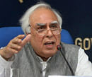 Union Ministers P Chidambaram and Kapil Sibal addressing a press conference in New Delhi on Monday. PTI