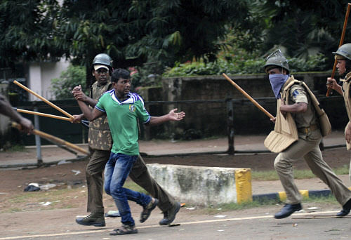 Police wield their batons against a supporter of Congress party during a protest outside Odisha state legislative assembly at Bhubaneswar on September 6, 2012.  AP