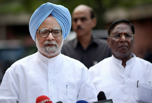 Prime Minister Manmohan Singh with MoS at PMO V Narayanasamy addresses the media at Parliament on the last day of monsoon session in New Delhi on Frid