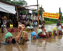 Protesting village women shout slogans as they stand in water during the Jal Satyagraha or insistence on truth by water at Ghogal village, in Khandwa area, in the central Indian state of Madhya Pradesh, Friday, Sept. 7, 2012. AP