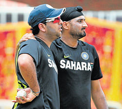 Indian cricketers Yuvraj Singh (left) and Harbhajan Singh mull a point  during a training session at the MA&#8200;Chidambaram stadium on Monday. AP