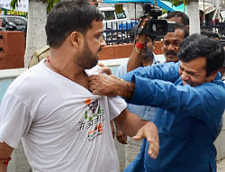 Congress workers manhandle one of the Anna Hazare supporters, who were protesting over coal scam during MoS for Commerce and Industry, Jyotiraditya Scindia's press conference in Patna on Tuesday. PTI