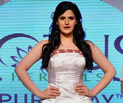 Actress Zarine Khan walks on the ramp at a fashion show. PTI