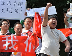Anti-Japanese demonstrators march during a protest over the disputed Diaoyu islands, known as Senkaku in Japan, outside the Japanese Embassy in Beijing on September 12, 2012. China has dispatched two patrol ships to 'assert its sovereignty' over islands at the centre of a row with Japan, state media said on September 11, as Tokyo completed its purchase of the disputed territory. AFP