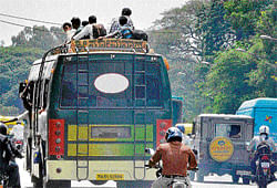 overcrowded: People travel on the rooftop of private buses in the City on Thursday. dh photo/B k janardhana