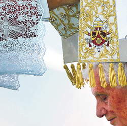 LIVING IN FAITH: A Mitre is placed on Pope Benedict XVI head during an open-airmass in Beirut on Sunday. AFP
