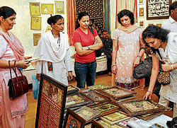 Smart deal: Visitors throng Dastkari exhibition to buy their share of calligraphed products.