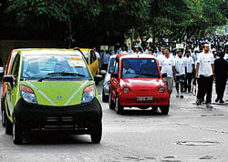 Tata Nano on a green run with cyclists