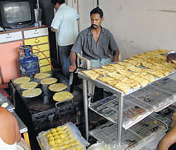 Obbattu and Kadabu being prepared and sold at a sweet stall in Rajajinagar II Block on the occasion of Gowri-Ganesha festival on Tuesday. dh photos