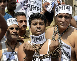 Traders chain themselves at a demonstration against UPA government over FDI in retail, in Bhopal on Wednesday. PTI