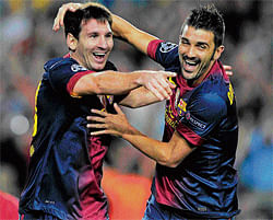 little wonder: Lionel Messi (left) celebrates his second goal with David Villa. AFP