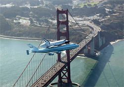 In this photo provided by NASA, space shuttle Endeavour and its 747 carrier aircraft soar over the Golden Gate Bridge in San Francisco during the final portion of its tour of California, Friday, Sept. 21, 2012. AP
