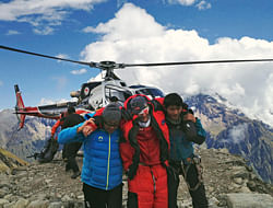 In this photo provided by Nepalese airline Simrik Air, an injured victim, center, of an avalanche is rescued at the base camp of Mount Manaslu in northern Nepal, Sunday, Sept. 23, 2012. The avalanche swept away climbers on a Himalayan peak in Nepal on Sunday, leaving at least nine dead and six others missing, officials said. (AP Photo