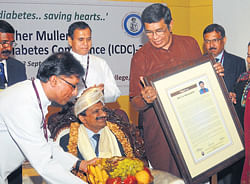 Renowned Cardiologist Dr C N Manjunath being felicitated by MP Oscar Fernandes during the inauguration of Cardio-Diabetes Conference in Mangalore.