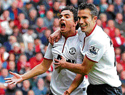 relief and joy: Rafael (left) celebrates with Robin van Persie after scoring the equaliser for  Manchester United against Liverpool at Anfield on Sunday. AFP