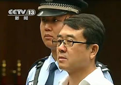 This file frame grab taken from Chinese television CCTV on September 18, 2012 shows former police chief Wang Lijun (R) facing the court during his trial in Chengdu, in southwest China's Sichuan province. Chinese ex-police chief Wang Lijun, who triggered a scandal that shocked the Communist Party, was sentenced to 15 years in prison on September 24, 2012 for defection and other crimes, Xinhua reported.  AFP PHOTO / FILES / CCTV -