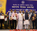 Prime Minister Manmohan Singh and Minister for Science and Technology and Earth Sciences Vayalar Ravi with recipients of Shanti Swarup Bhatnagar Prizes 2011 & CSIR Awards 2012 during the 70th Foundation Day function of Council of Scientific & Industrial Research (CSIR) at Vigyan Bhawan in New Delhi on Wednesday. PTI Photo