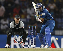 New Zealand's wicketkeeper Brendon McCullum, left, watches Sri Lanka's batsman Tillakaratne Dilshan play a shot during the ICC Twenty20 Cricket World Cup Super Eight match in Pallekele, Sri Lanka, Thursday, Sept. 27, 2012. AP