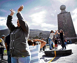 seemingly close: Visitors take pictures at the Middle of the World monument, which is said to be at the Equator, in San Antonio de  Pichincha, Ecuador. NYT