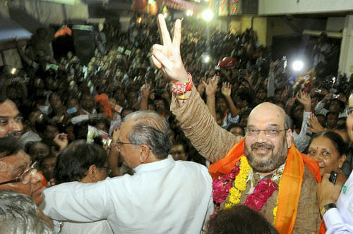 Former Gujarat minister Amit Shah wave his supporter at his residence in Ahmedabad on Friday. Shah suspected in the Sohrabuddin Sheikh encounter case.PTI Photo(