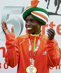 maharajah!: Edwin Kipyego is delighted with his triumph in the Delhi Half-Marathon on Sunday. AFP