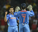 India's Virat Kohli (L) celebrates with team mate Mahendra Singh Dhoni after dismissing Pakistan's Mohammad Hafeez during the ICC World Twenty20 Super 8 cricket match at the R Premadasa Stadium in Colombo September 30, 2012. REUTERS