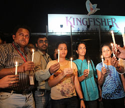 Kingfisher employees, engineers and pilots take part in a candle light march from airport to Kingfisher House in Mumbai on Thursday evening. PTI