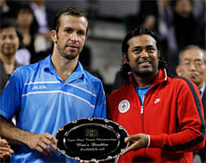 Radek Stepanek of the Czech Republic (L) and Leander Paes of India pose with their runner-up trophy after losing to Alexander Peya of Austria and Bruno Soares of Brazil in the men's doubles finals match at the Japan Open tennis championships in Tokyo October 7, 2012. REUTERS
