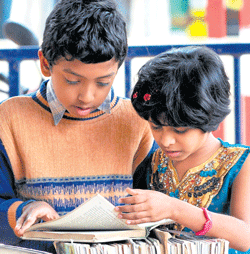 Young readers: Children browse through books at the Pustaka Parishe on Sunday.  Dh Photo/ Savitha B R