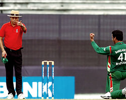 In this photograph taken on October 9, 2008, Bangladeshi cricketer Abdur Razzak (R) gestures towards umpire Nadir Shah as he celebrates the dismissal of unseen New Zealand batsman Scott Styris during the first one day international (ODI) between Bangladesh and New Zealand at The Sher-e-Bangla National Cricket Stadium in Dhaka. Umpires at the centre of a bribery scandal denied October 9, 2012, that they were willing to fix matches for cash as cricket authorities announced an urgent probe into the allegations aired in a television sting. An undercover investigation by the private India TV channel allegedly found that six umpires, including one who is a regular fixture on the international circuit, were willing to give decisions or provide inside information on the teams and playing conditions in return for illicit payments. AFP PHOTO/Farjana KHAN GODHULY/FILES