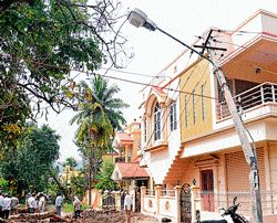 aftermath of rain: Residents of houses constructed under Nurm at Medarakeri near Bamboo Bazaar are anxious over the quality of construction as dampness occurred on the walls