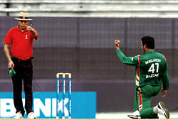 File photo of Bangladeshi cricketer Abdur Razzak (R) gesturing towards umpire Nadir Shah at The Sher-e-Bangla National Cricket Stadium in Dhaka. Cricket authorities have suspended six umpires at the centre of claims made by an television programme that they could be bribed to make favourable decisions during games. Three of those named were from Sri Lanka, while two were from Pakistan. The sixth was Nadir Shah, one of two Bangladeshi members of the ICC's international panel which officiates in matches around the world. AFP