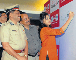 signing up for a cause: Additional Commissioner of Police (Traffic) M A Saleem, actor Ramya Barna and others at the launch of Quartz Safety Month, to support the cause of  road safety, organised by the Bangalore Traffic Police in the City on Wednesday. kpn