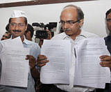 Members of India Against Corruption Arvind Kejriwal and Prashant Bhushan showing documents during a press conference in New Delhi. PTI