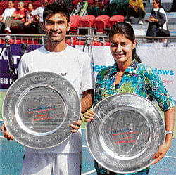 ALL&#8200;SMILES Jeevan Neduncheziyan (left) and Prerna  Bhambri pose with their spoils after winning the mens and womens titles in the National tennis championship. PTI
