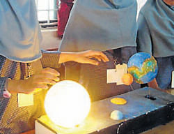 Light of knowledge: Students display a model of solar syatem during the inter-institutional science exhibition organised at NITK Surathkal on Saturday. DH Photo