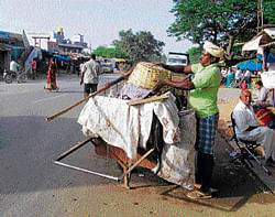 Clean deal: Sanitation workers hired by the Chikkatirupati Gram Panchayat in Malur taluk clean the streets.  dh photos