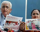 Union Law Minister Salman Khurshid with wife Louise Khurshid shows photographs of relief camps being organised by their NGO during a press conference in New Delhi on Sunday. PTI