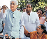 Pointing fingers: Union Law Minister Salman Khurshid gestures angrily at a media person during a press conference in New Delhi on Sunday as his wife, Louise, restrains him. PTI