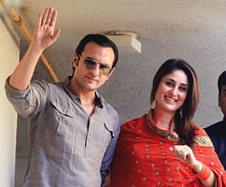 Bollywood stars Saif Ali Khan and Kareena Kapoor arrive at their balcony to greet their fans after getting married in Mumbai on Tuesday. AP