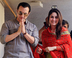 Bollywood stars, Saif Ali Khan, left, and Kareena Kapoor, step out on a balcony to greet waiting fans after getting married in Mumbai, India, Tuesday, Oct. 16, 2012. The Press Trust of India reported the couple married Tuesday in a small official ceremony in Khans house in Mumbai with a few friends and family members in attendance. (AP Photo)