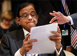 G24 Chair and India's Finance Minister Palaniappan Chidambaram reads a documents prior to the International Monetary and Financial Committee at the annual meetings of the IMF and the World Bank Group in Tokyo.. REUTERS
