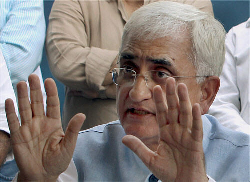 Union Law Minister Salman Khurshid gestures during a press conference in New Delhi on Sunday. PTI Photo by Shahbaz Khan