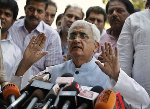Law Minister Salman Khurshid addresses a press conference to refute charges of corruption against a trust he runs for the disabled, in New Delhi, India, Sunday, Oct. 14, 2012. (AP Photo/ Mustafa Quraishi)